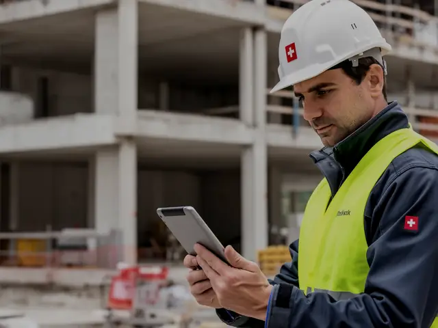 Bauleiter mit Tablet auf einer Schweizer Baustelle